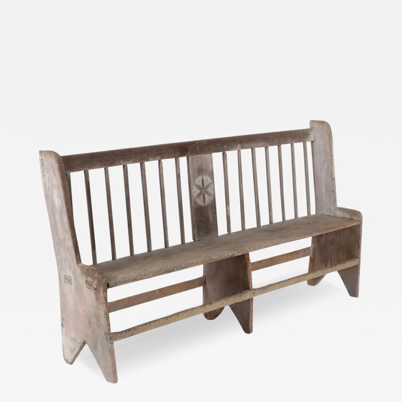 An antique wooden bench circa 1800.